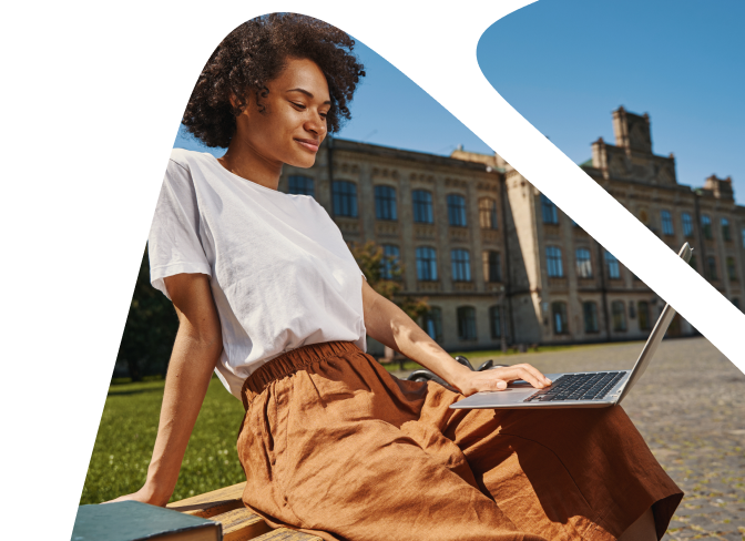 A woman with a laptop sitting on the bench